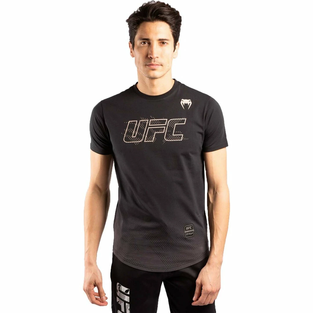 Playwell Venum MMA Shorts & Clothing Venum X UFC Authentic Fight Week T Shirt - Black/Gold 1 Playwell Venum MMA Shorts & Clothing Venum X UFC Authentic Fight Week T Shirt - Black/Gold
